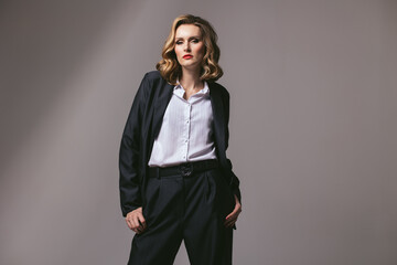 Stylish business successful confident woman in black work suit. Businesswoman in an oversized...