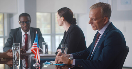 Group of business people brainstorming together in meeting room
