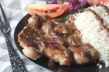 detail shot of grill chicken , rice and salad on plate on table 
