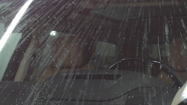 Wet car windshild. Drops run down