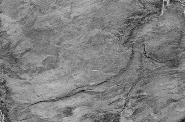 Black and white background. Gray rock texture. Grunge stone background. The texture of the mountains. Close-up. Grunge banner with volumetric rock texture