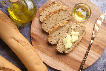 slice of butter and whole meal bread on chopping board 