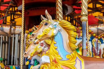 Fototapeta na wymiar Brightly painted carousel pony at funfair.