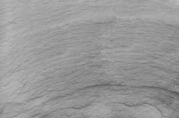 Black and white background. Gray rock texture. Grunge stone background. The texture of the mountains. Close-up. Grunge banner with volumetric rock texture