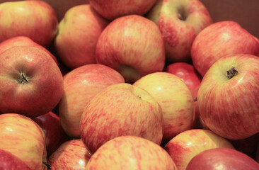 Background of ripe pink apples in the store