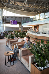 Businessman enjoying his beverage before the international flight