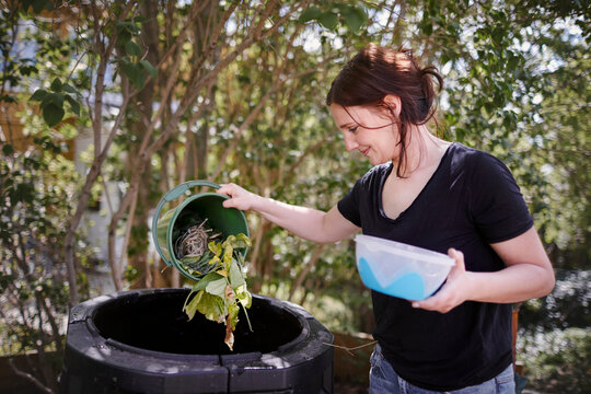Woman throwing out organic waste