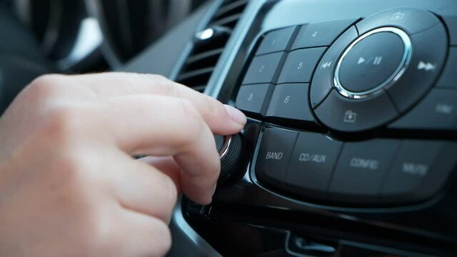 Woman hand control radio or music in car