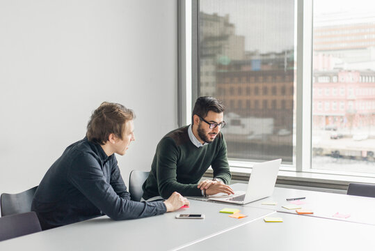 Coworkers talking in board room