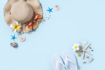 Summer beach background design concept with shells, hat, slipper on blue background.