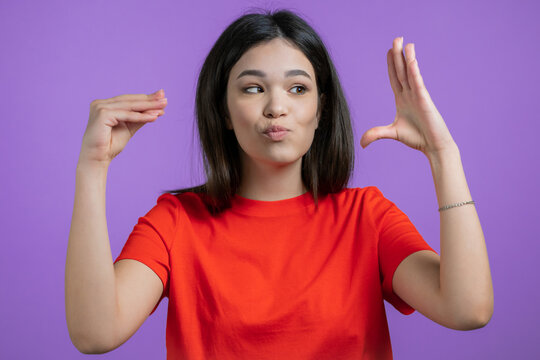 Pretty mixed race woman showing bla-bla-bla gesture with hands isolated on purple background. Empty promises, blah concept. Lier.
