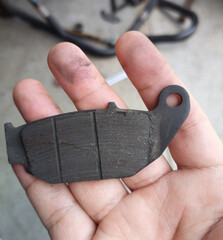 The brake pads of the motorcycle that the mechanic has changed. due to out of use