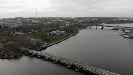 View of the river with two bridges and the city embankment. Residential buildings in the background. Nikolaev, Ukraine