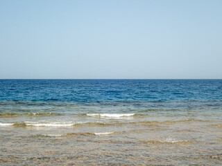 Fototapeta na wymiar View to the sea and empty blue sky
