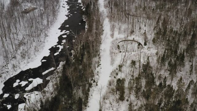 Katahdin Ironworks aerial flying backwards over Pleasant River Winter snow 