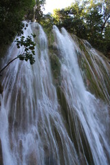 Fototapeta na wymiar power waterfall in the shadow of the mountain 