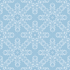 Lace seamless white pattern. Decorative blue background