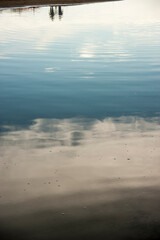 reflections of people on the water of the sea