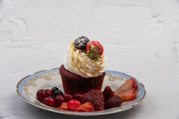 cupcake with strawberries on a light background close-up