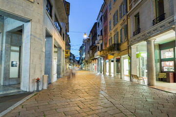 Fototapeta na wymiar Typical street of the historic center of an Italian city in the evening. Historic center of Varese, Corso Matteotti, northern Italy