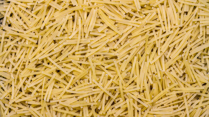 Pasta background, thin, organic raw vermicelli noodles, food texture