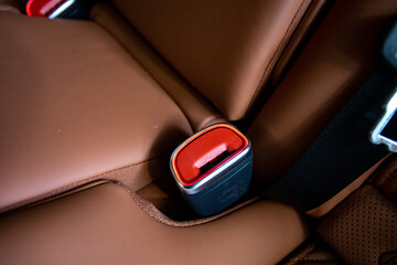 Obraz premium Driver's seat belt in a modern car interior with orange seats, safety concept