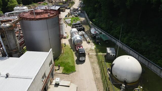 Truck transporting heavy industry equipment to the destination point. Aerial view. 