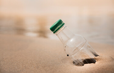 Environment, Ecology Care, Renewable Concept. Plastic Bottle Waste on the Beach Sand or Riverside. Dirty Beach