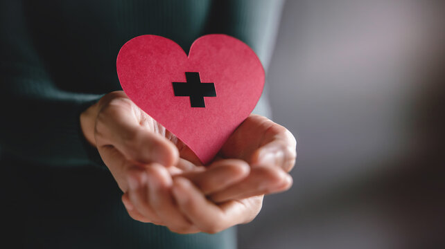 Love, Health Care, Donation and Charity Concept. Close up of Volunteer Holding a Heart Shape Paper