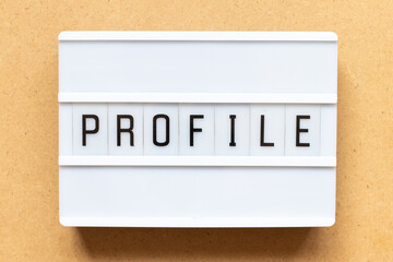 Lightbox with word profile on wood background