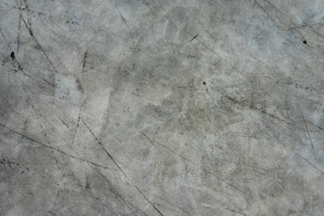 The background of the gray concrete floor is exhausted by black stripes.