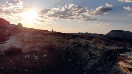 AIR. Drone photo silhouette of a woman on a mountain in the morning with vintage light