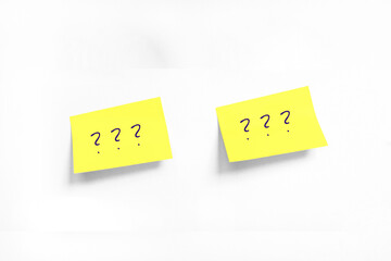 Two Yellow stickers with Question mark on white Whatman paper. Concept learn, starting education. Handwriting text close up isolated, copy space