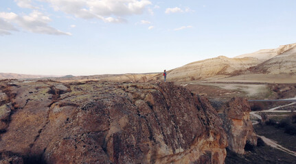 AIR. Drone photo silhouette of a woman on a mountain in the morning with vintage light