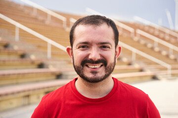 Outdoor portrait of an ugly man looking at the camera smiling. Close-up of a cheerful male face....