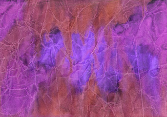 Pink, orange, blue, purple and lilac watercolor stains and streaks on crumpled paper