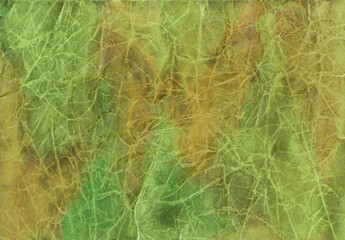 Yellow, green, beige, ocher, brown watercolor stains and stripes on crumpled paper
