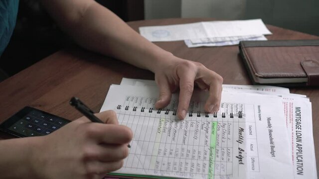 Checking of household expenses and family finances during the COVID-19 crisis. The Notebook and Pen: This is the oldest method for budgeting. Housewife writes down all sources of income and expenses