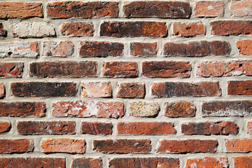 Fototapeta premium Old wall made of red bricks. Background with the surface of a brick wall.