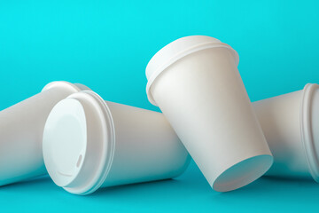 Spilled White Paper Coffee Cups on Green Background, Paper Coffee Cup Template.