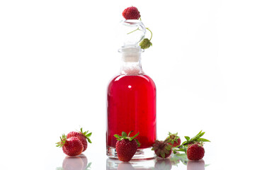 sweet cooked strawberry syrup in a glass decanter
