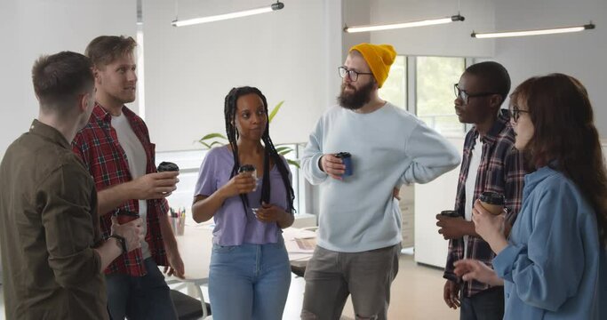 Successful business team talking on coffee break.