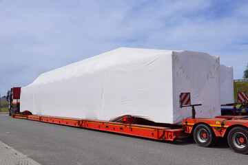 Very long vehicle. Oversize load or exceptional convoy. A truck with a special semi-trailer for...