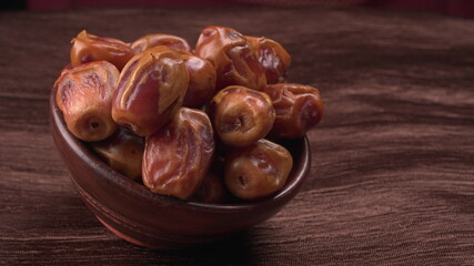 Dates in wooden bowl on background. dried dates fruit.