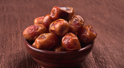 Dates in wooden bowl on background. dried dates fruit.