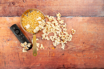 Popcorn shot from above in a copper saucepan on a wooden background with space for text
