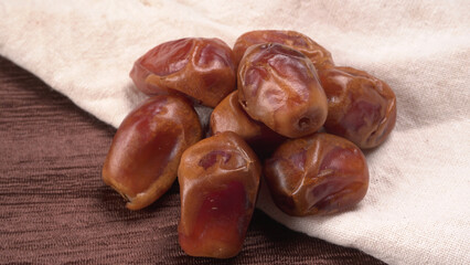 Dates in wooden bowl on background. dried dates fruit.