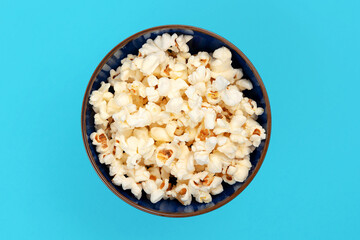 Popcorn shot from above on a blue background with space for text