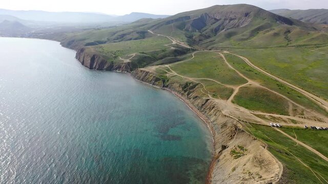 View of the bay at Cape Chameleon(Toprakh-Kaya cape) Crimea. Aerial video of cliffed coast line cape Chameleon Crimea Rocks line the shore of Black sea. Koktebel' area, Crimea. 