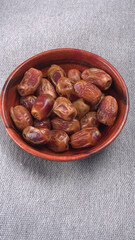 Dates in wooden bowl on background. dried dates fruit.